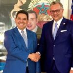 رجلان يتصافحان أمام علمي فرنسا والمغرب