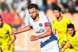 مشجع لكرة القدم يحمل شعار الاتحاد السعودي لكرة القدم