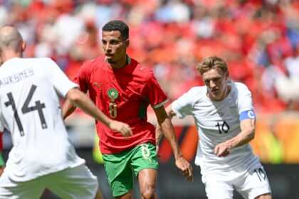 لاعب كرة قدم في الملعب يرتدي قميصاً أزرق ورقمه 8.