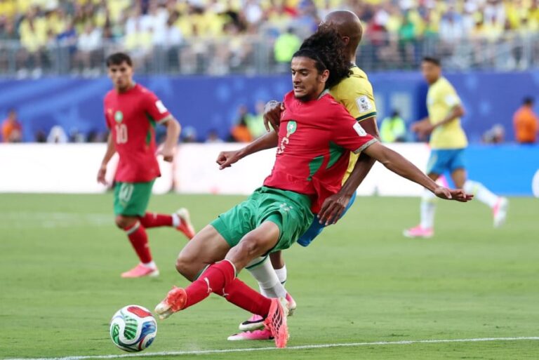 لاعب مغربي يمسك لاعبًا برازيليًا.
