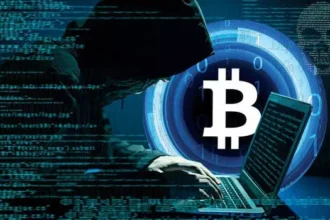 شاب يرتدي قلنسوة يستخدم حاسوباً، خلفية تقنية عملات مشفرة وبيتكوين.