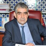رجل يرتدي بدلة يجلس على كرسي