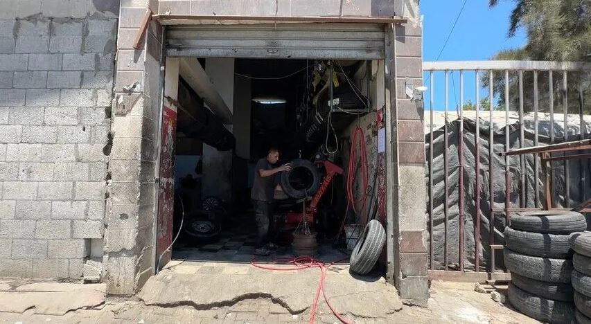 رجل يصلح إطار سيارة بأساليب بدائية