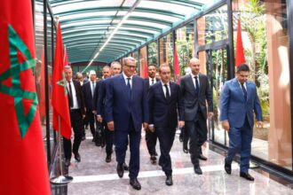 رئيس المغرب بجوار رئيس أساقفة الرباط يحدقان في الممر