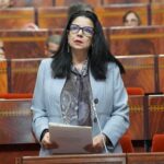الوزيرة أمل الفلاح تتحدث أمام الميكروفونات خلال مؤتمر صحفي.
