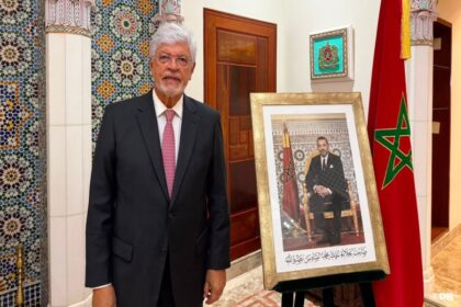 سفير برازيلي سابق يتحدث وبجواره صورة للملك محمد السادس