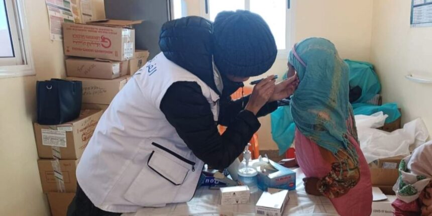 امرأة تحقن طفلاً بإبرة طبية