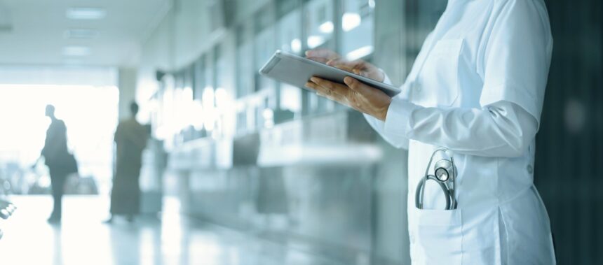 طبيب يعاين ملفاً طبياً رقمياً على جهاز آيباد