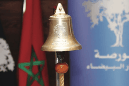 جرس ذهبي بشكل تفاحة بجانب العلم المغربي