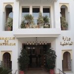 مبنى بواجهة معمارية يونانية وعلامتين على جانبه