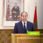 متحدث رسمي ببدلة زرقاء أمام منصة إعلامية