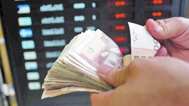 أوراق نقدية من فئة خمسين درهماً مع آلة عد النقود