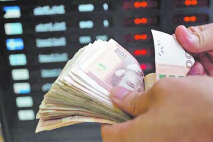 يدا بيد تحملان حزمة أوراق نقدية مختلفة، مما يعكس قيمة العملات.