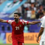 نزار الرشدان بقميص أحمر وأبيض يحمل الرقم 21.