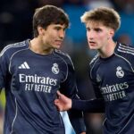 لاعبا كرة قدم بقميص ريال مدريد يبتسمان.