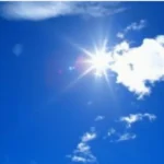 سماء زرقاء صافية مع شمس ساطعة وغيوم