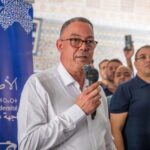 فوزي لقجع يتحدث إلى الجمهور بحماس.